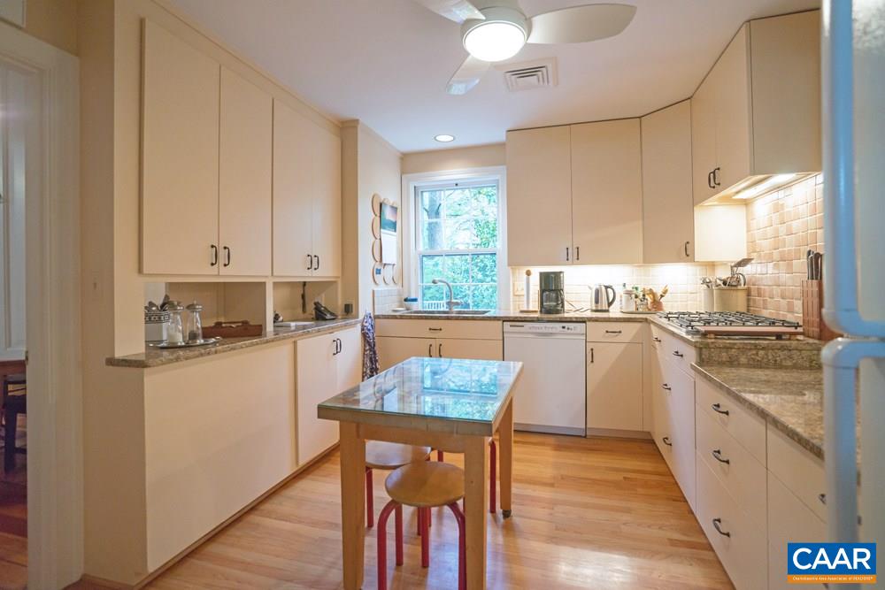 2040 Thomson Road Charlottesville, VA 22903 - Photo 10 of 23 a kitchen with granite countertop white cabinets and white appliances