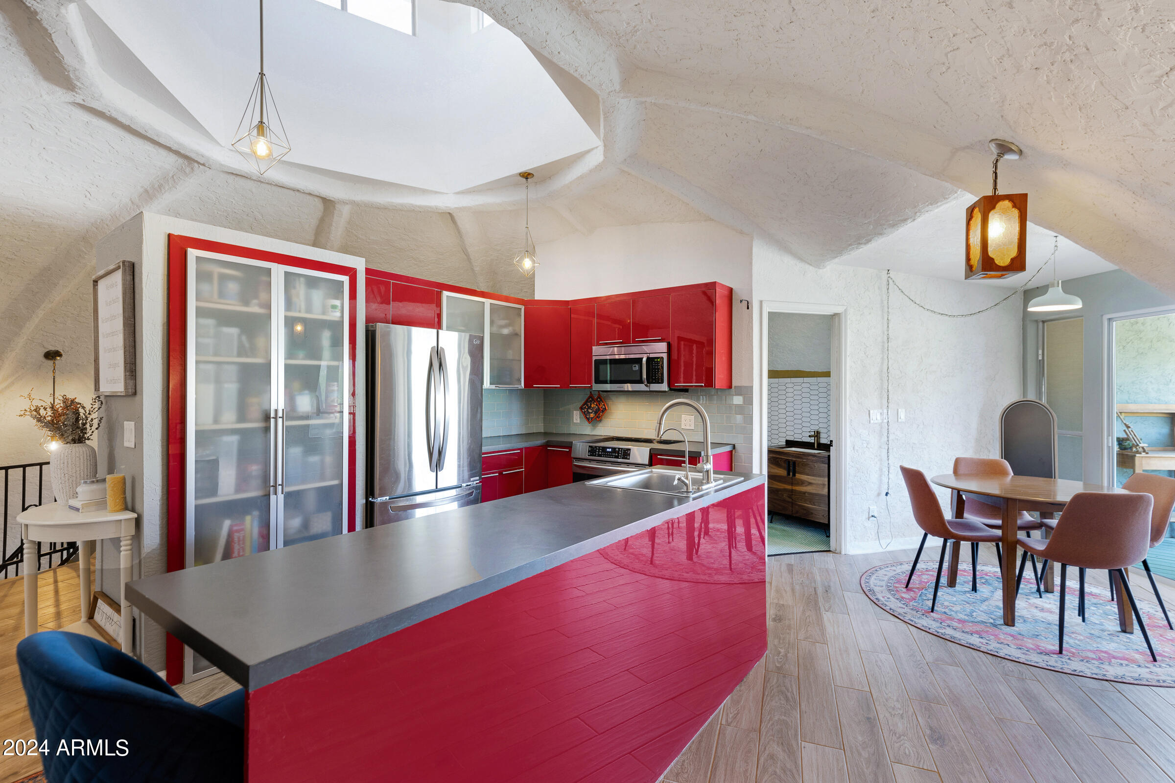 625 South Arroya Road Apache Junction, AZ 85119 - Photo 9 of 48 a kitchen with sink refrigerator dining table and chairs
