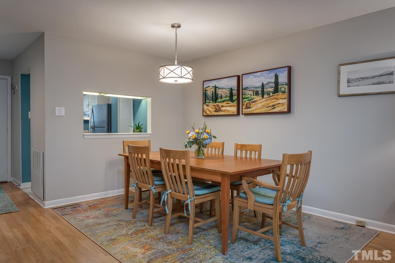 118 Ridge Trail Chapel Hill, NC 27516 - Photo 12 of 31 a view of a dining room with furniture wooden floor and chandelier