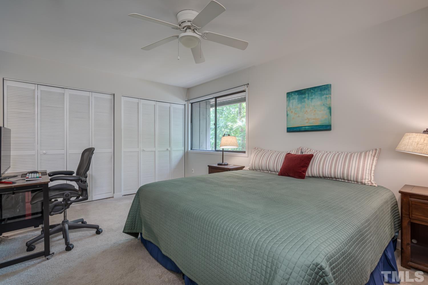 118 Ridge Trail Chapel Hill, NC 27516 - Photo 14 of 31 a bedroom with a bed a computer on a desk and a printer next to a window