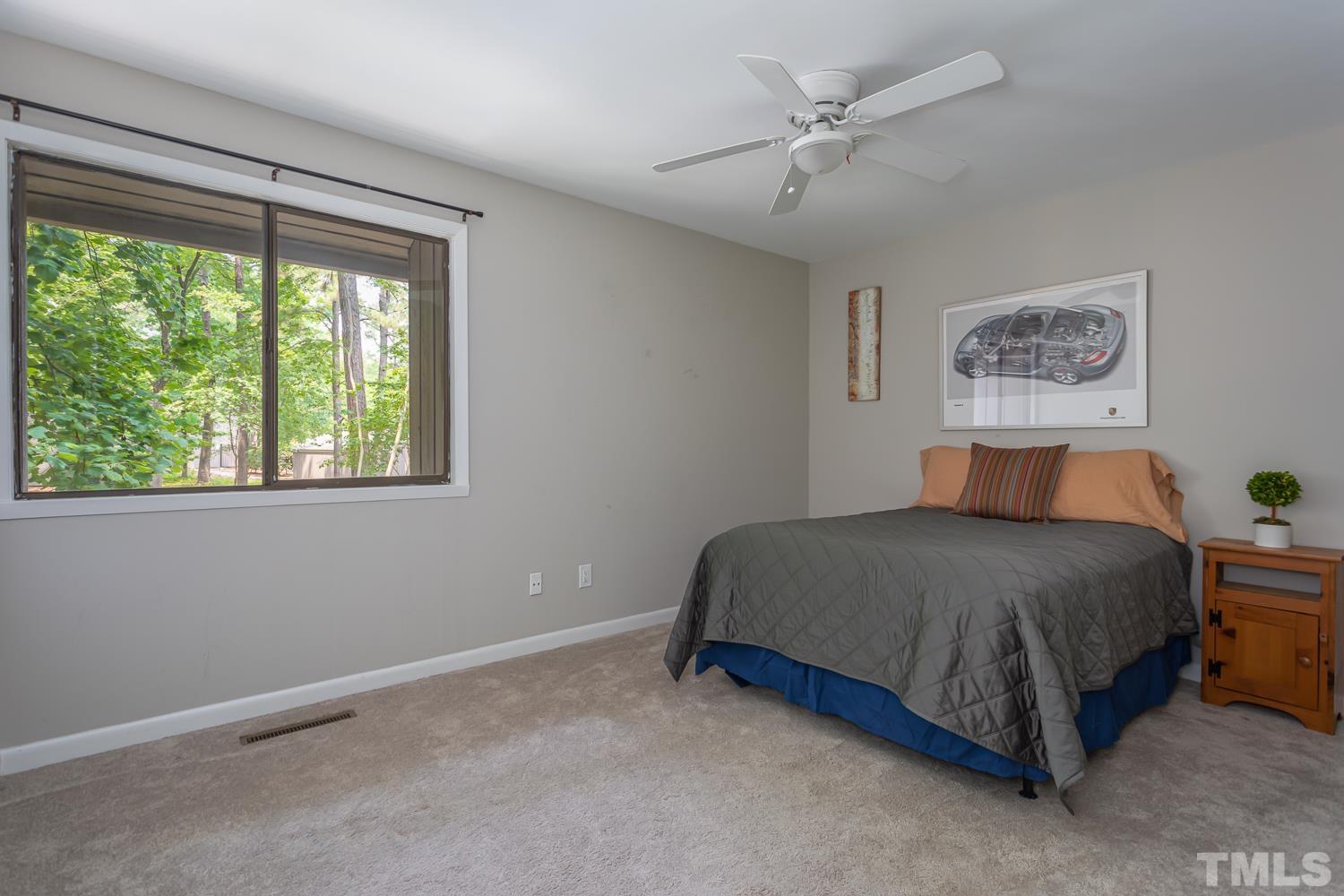 118 Ridge Trail Chapel Hill, NC 27516 - Photo 15 of 31 a bed sitting in a room next to a window