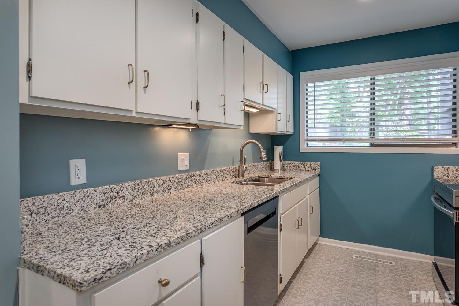 118 Ridge Trail Chapel Hill, NC 27516 - Photo 9 of 31 a kitchen with granite countertop white cabinets and sink