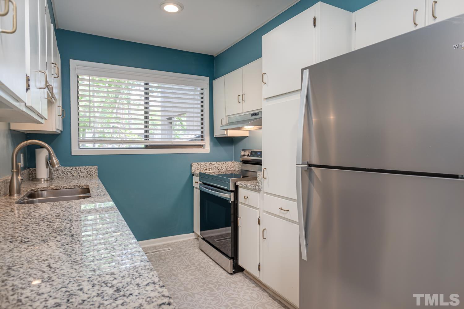 118 Ridge Trail Chapel Hill, NC 27516 - Photo 10 of 31 a kitchen with stainless steel appliances a refrigerator sink and cabinets