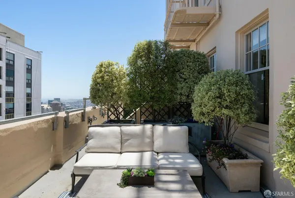 a view of a patio with couches and potted plants
