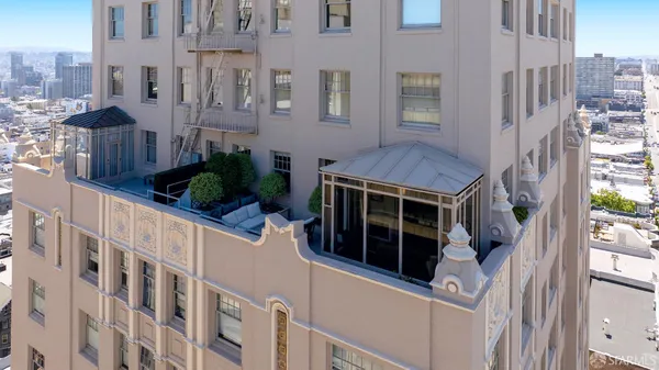 a view of a house with a window and wooden fence