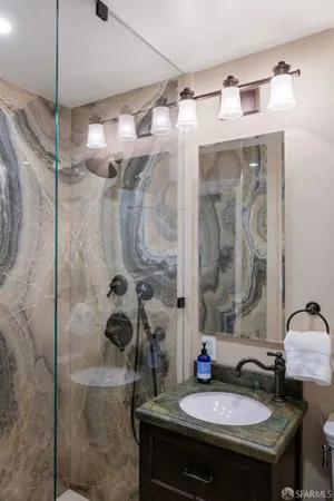 a bathroom with a sink a mirror and a shower