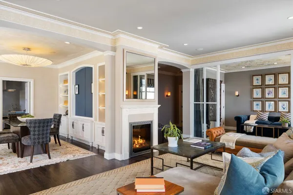 a living room with furniture fireplace and a table