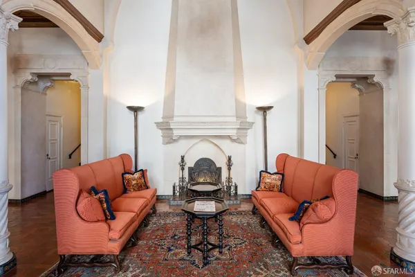 a living room with furniture rug and a fireplace