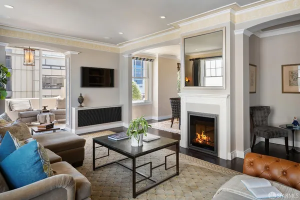 a living room with furniture a fireplace and a flat screen tv