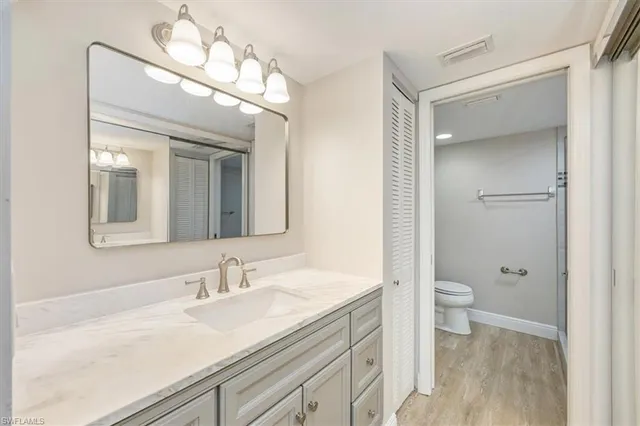 a bathroom with a sink a toilet and a mirror