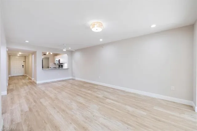 a view of a kitchen with a sink and a refrigerator