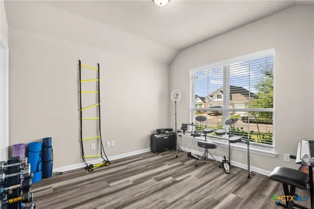 a view of a workspace with furniture and a window