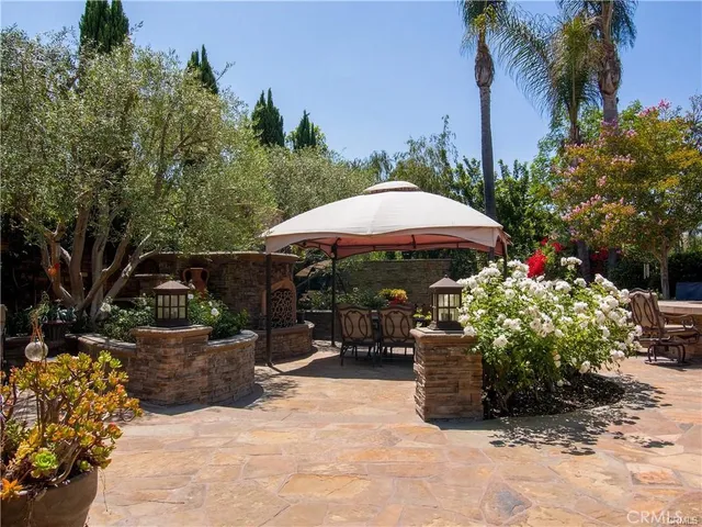 a view of a chairs and table under an umbrella in patio