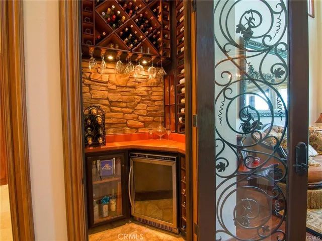 a dining room with furniture a chandelier and wooden floor