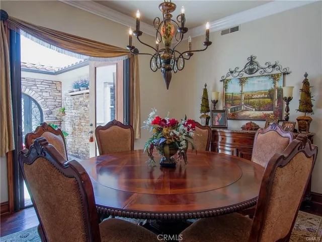 a kitchen with stainless steel appliances granite countertop a sink a stove and a wooden floors