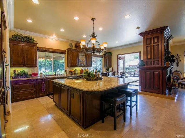 a kitchen with stainless steel appliances kitchen island granite countertop a stove and cabinets