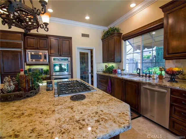 a living room with furniture a fireplace and a large window