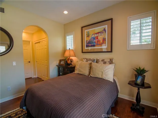 a bedroom with a bed and wooden cabinets
