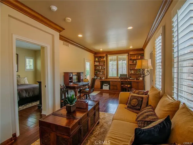 a bedroom with a bed and wooden cabinets