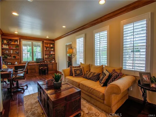 a view of a terrace with a bench and cars