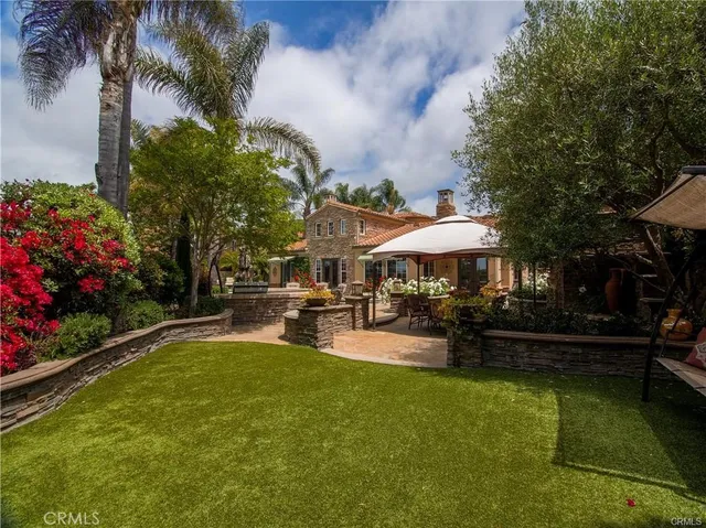 a view of backyard with seating area and green space