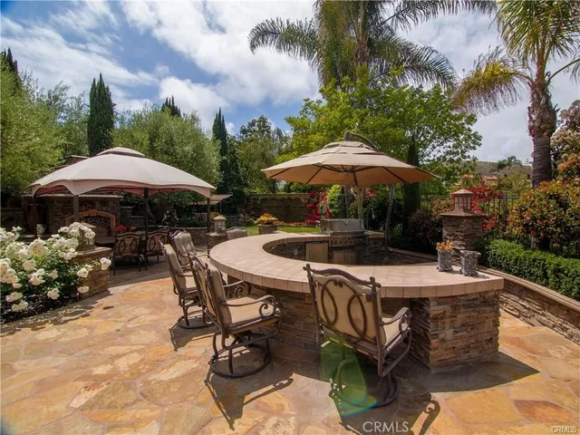 a patio with a patio table and chairs