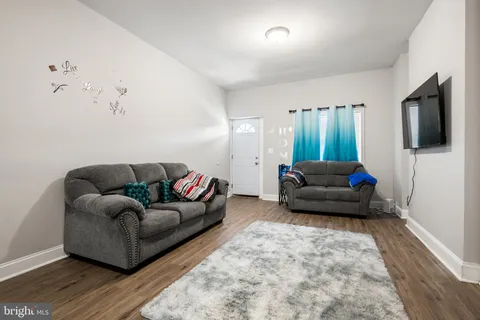 a living room with furniture and a toilet