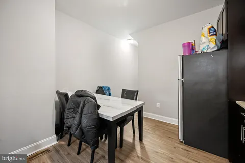 a kitchen with stainless steel appliances a refrigerator sink and cabinets