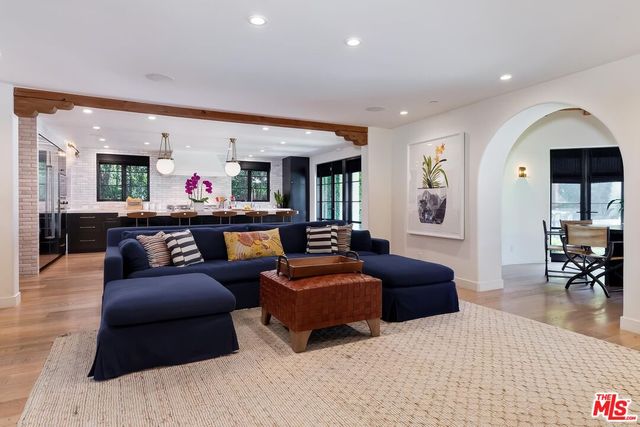 a kitchen with a kitchen island a sink stainless steel appliances and cabinets