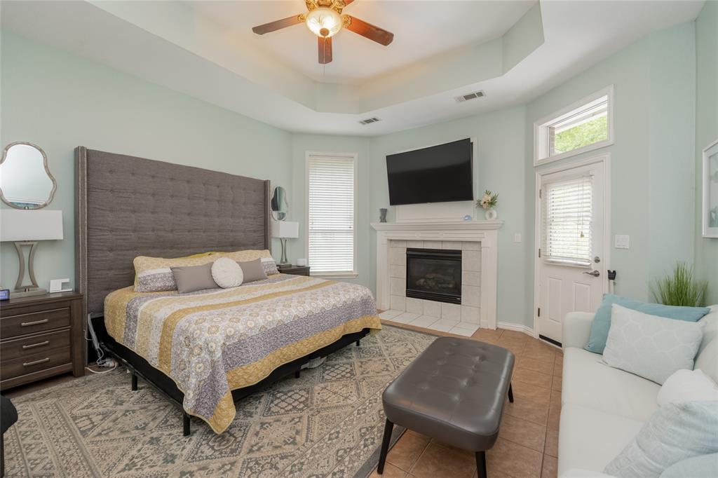 135 Kirkpatrick Road Ennis, TX 75119 - Photo 16 of 40 a spacious bedroom with a bed and a fireplace
