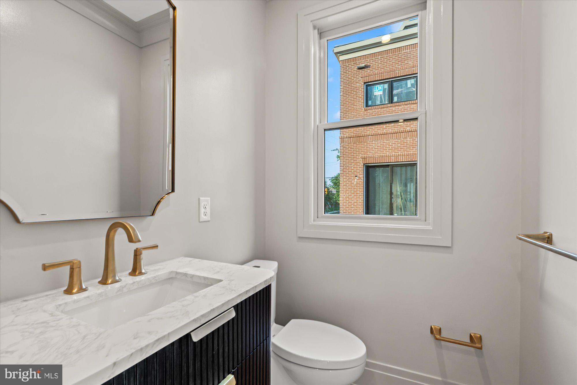 107 North West Alexandria, VA 22314 - Photo 25 of 65 a bathroom with a sink a toilet and mirror