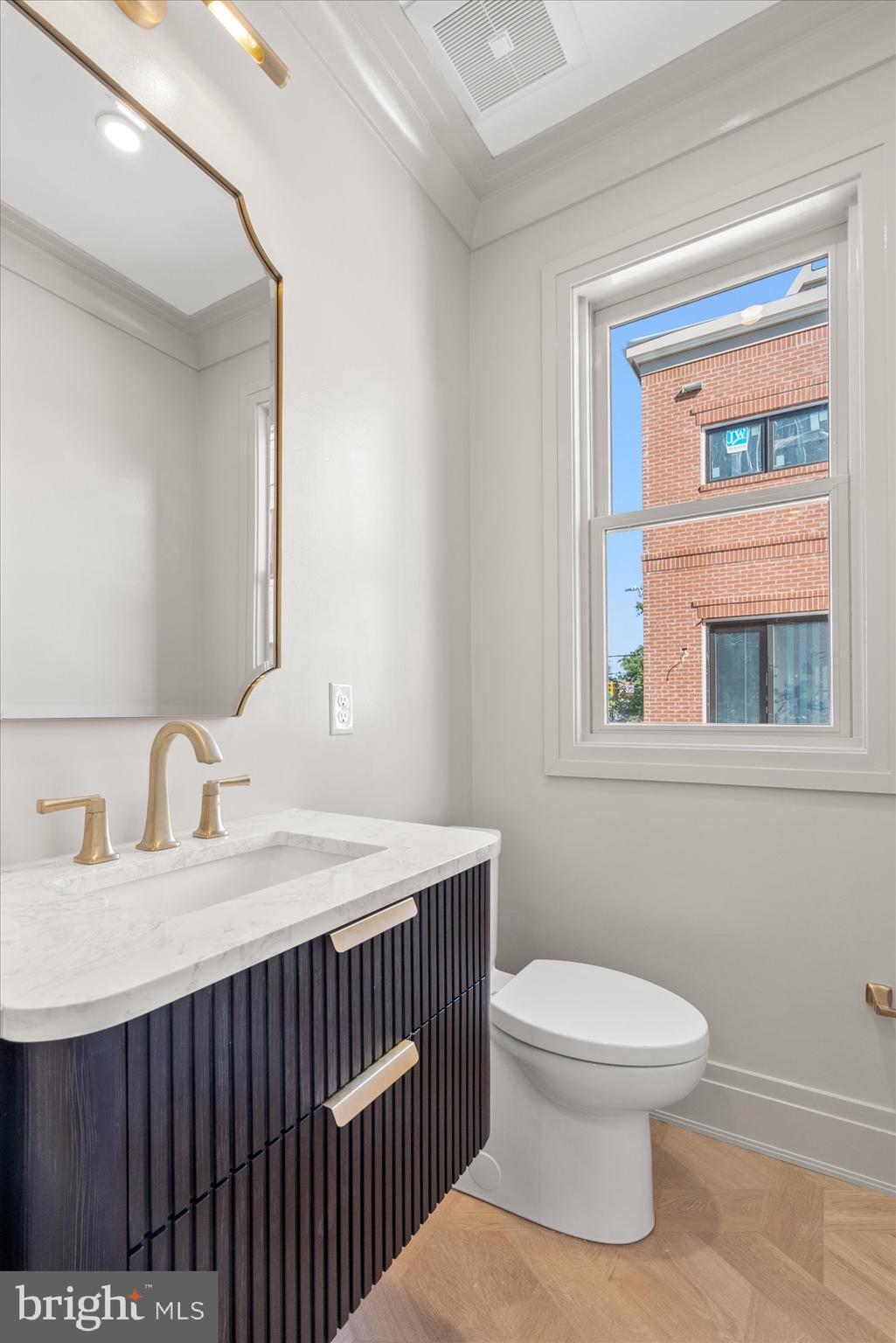 107 North West Alexandria, VA 22314 - Photo 26 of 65 a bathroom with a sink a toilet and a mirror