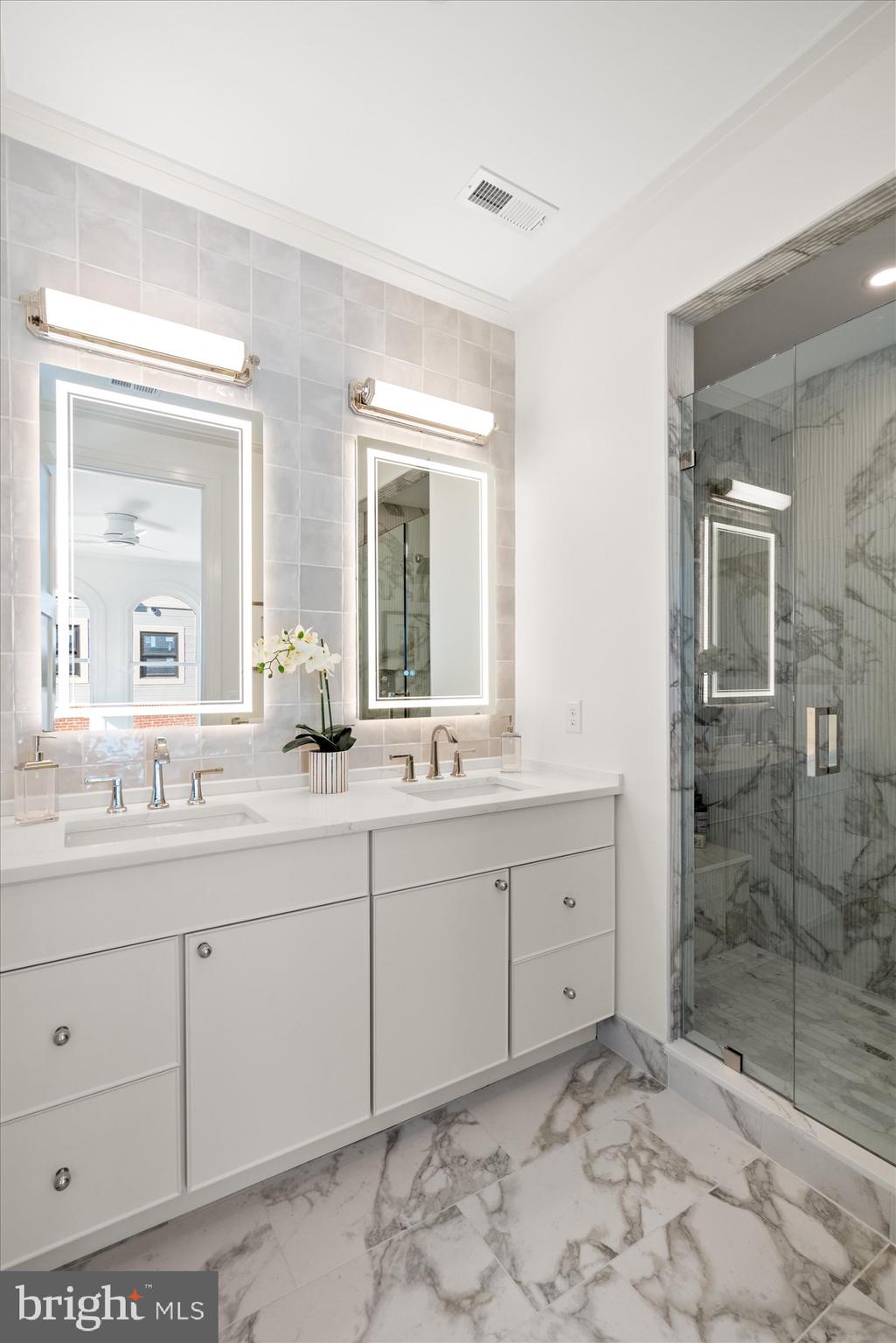 107 North West Alexandria, VA 22314 - Photo 40 of 65 a bathroom with a shower sink and mirror