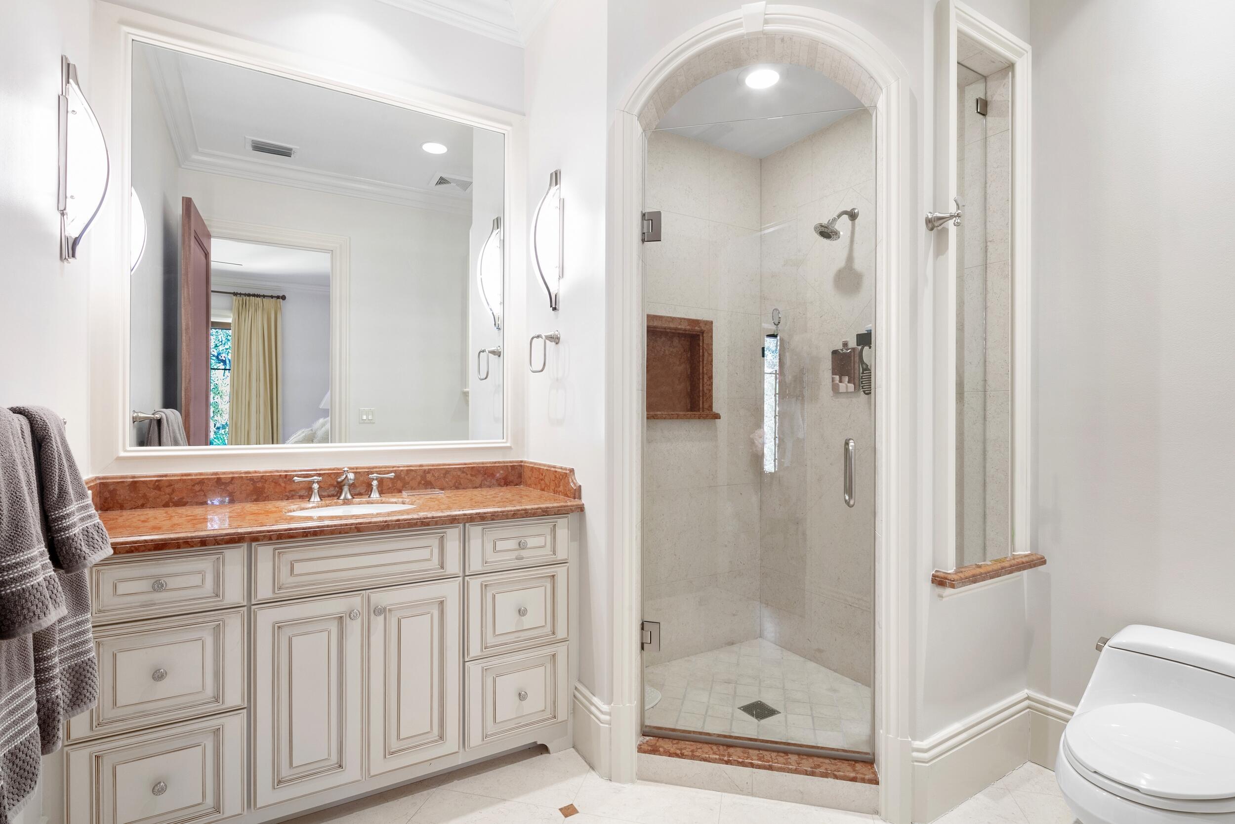 306 Villa Drive Jupiter, FL 33477 - Photo 22 of 30 a bathroom with a shower a mirror and a sink