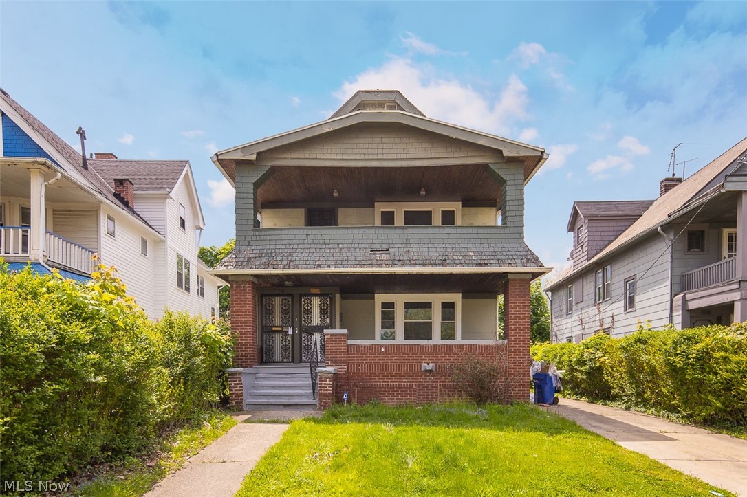 Two-story residence featuring a brick first floor and upper-level siding