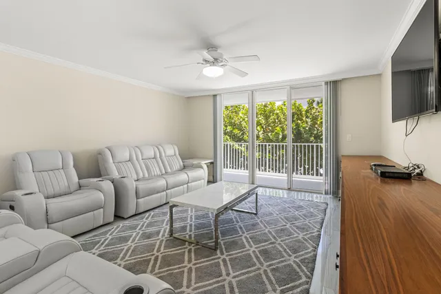 a living room with furniture and a floor to ceiling window