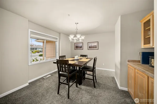 a view of a dining room with furniture and chandelier