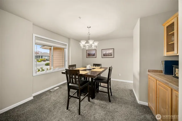 a view of a dining room with furniture and chandelier