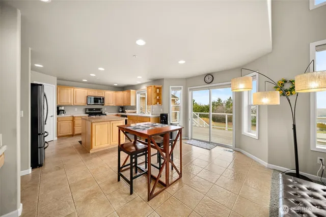 a kitchen with stainless steel appliances kitchen island granite top and refrigerator