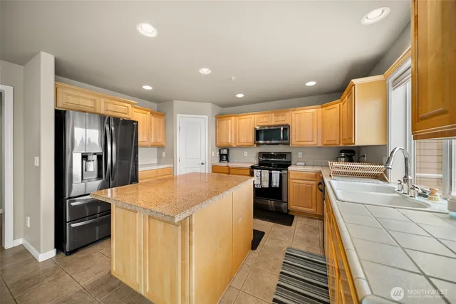 a large kitchen with stainless steel appliances lots of counter top space