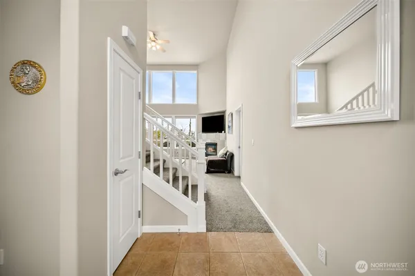 a view of a hallway with a livingroom and a window