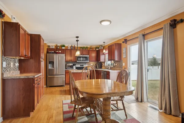 a dining room with furniture and large window