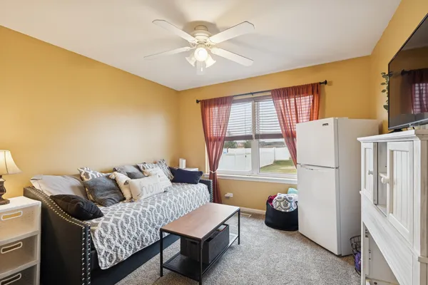 a bedroom with furniture and a large window