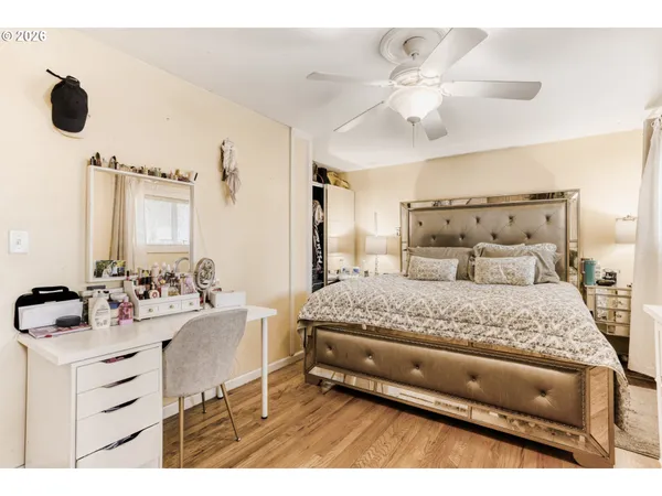 a bedroom with a bed mirror and window