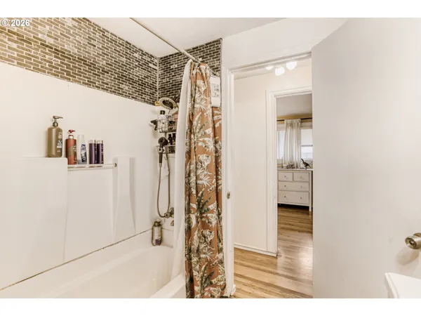 a view of a bathroom with a shower and a sink
