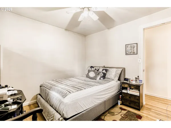 a bedroom with a bed and a night stand