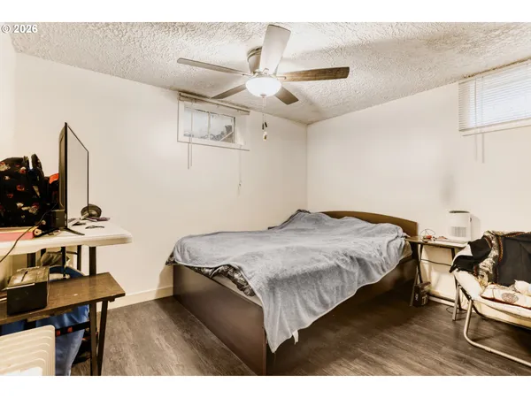 a bedroom with a bed and a desk