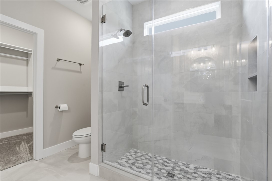 736 Stewart Gin Road Liberty, SC 29657 - Photo 29 of 50 This modern bathroom features a spacious walk-in shower and ample storage.