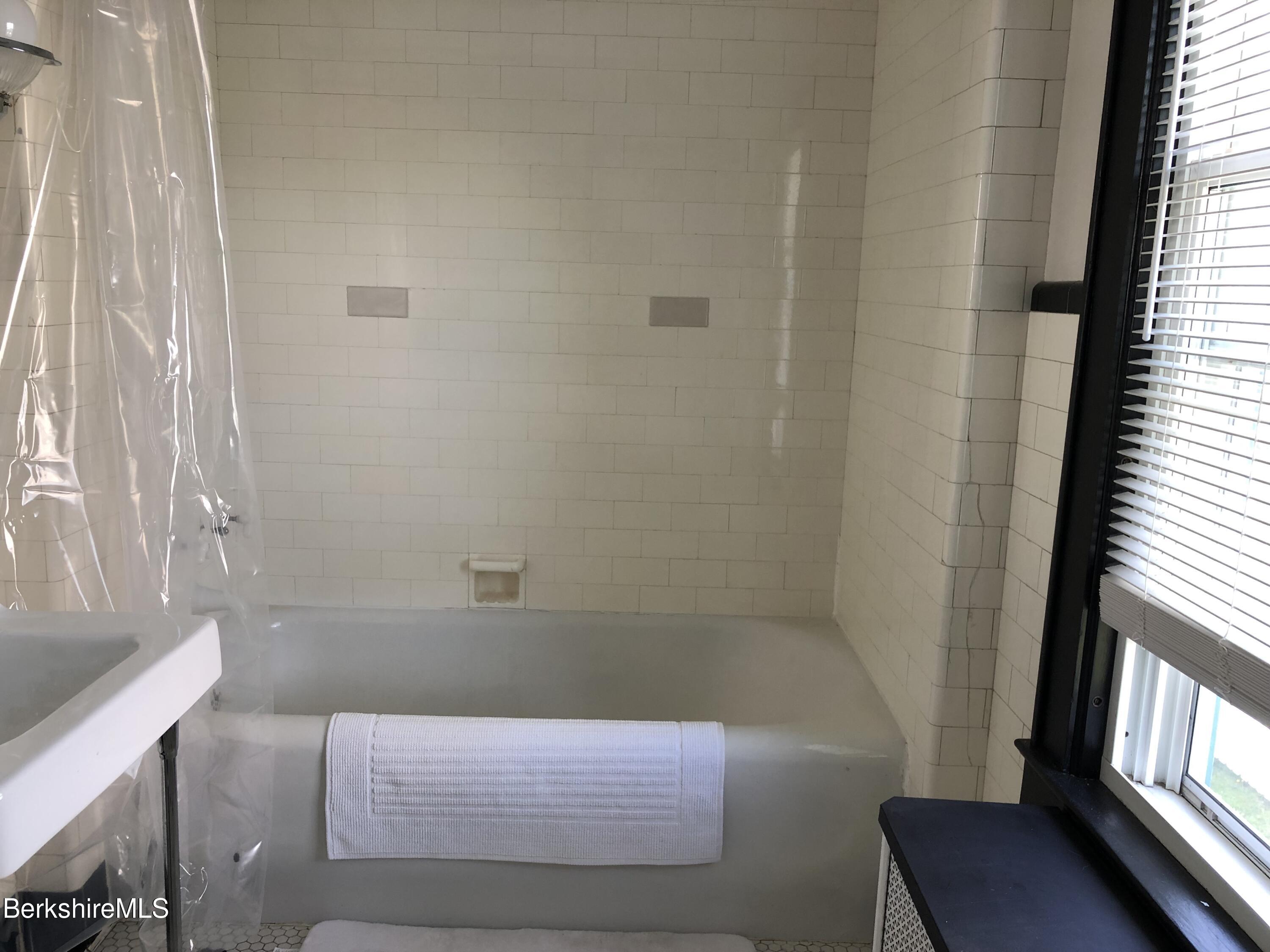9 Weston Street Pittsfield, MA 01201 - Photo 26 of 45 a bathroom with a bathtub and window