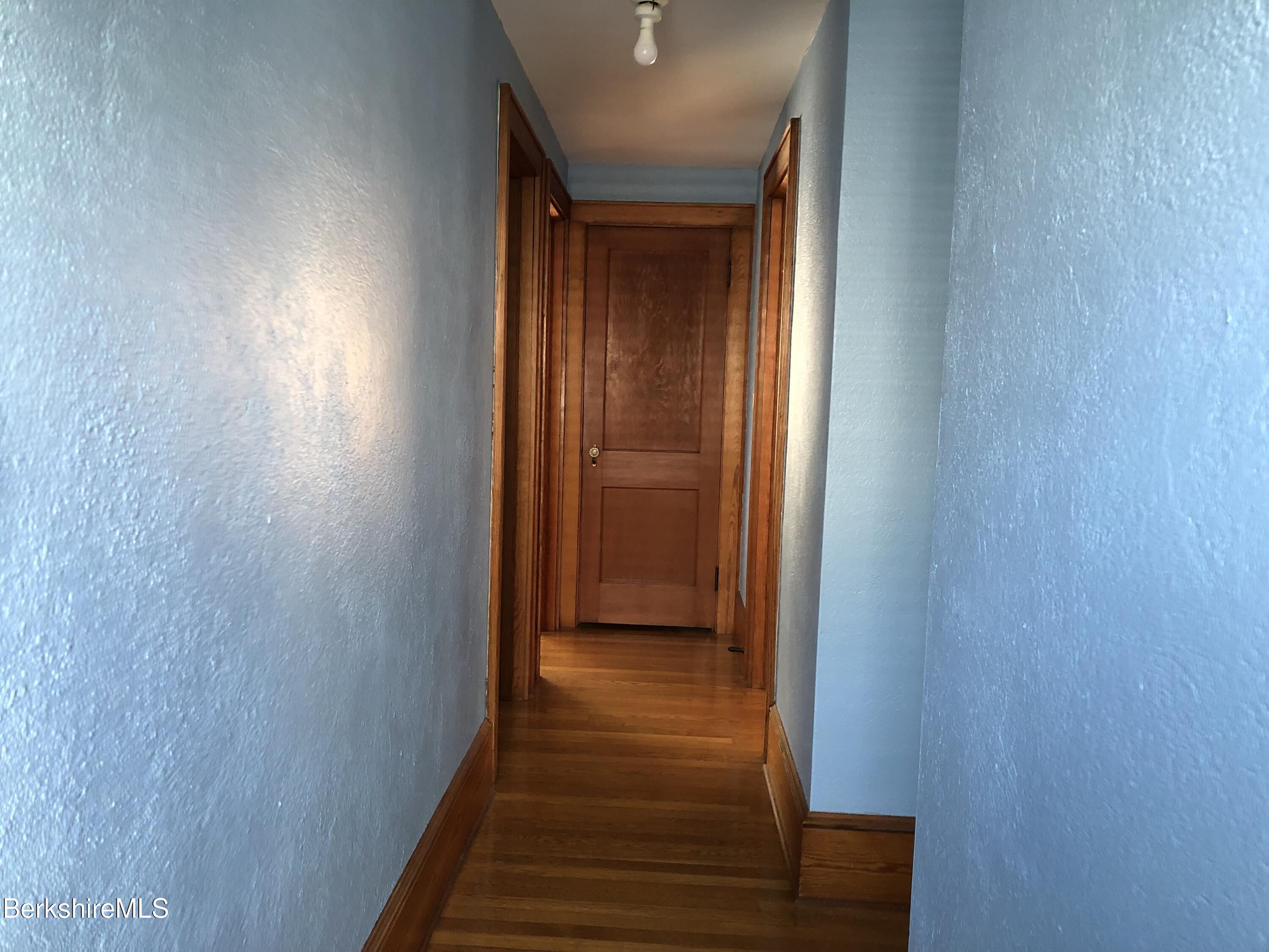 9 Weston Street Pittsfield, MA 01201 - Photo 27 of 45 a view of a hallway with wooden floor